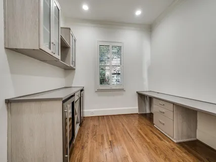 a view of a kitchen with wooden floor and electronic appliances