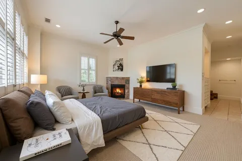 a bedroom with a bed and a fireplace