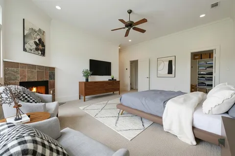 a bedroom with a bed furniture and a fireplace