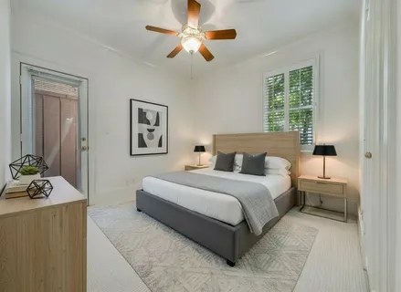 a spacious bedroom with a bed and window