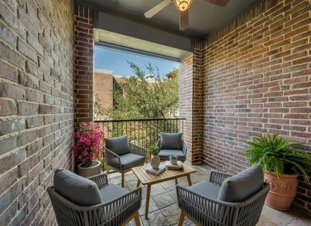 a balcony with furniture and a potted plant