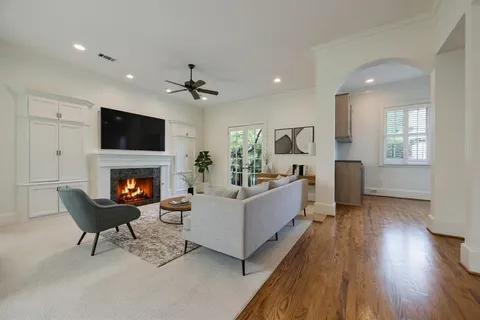 a living room with furniture a fireplace and a flat screen tv