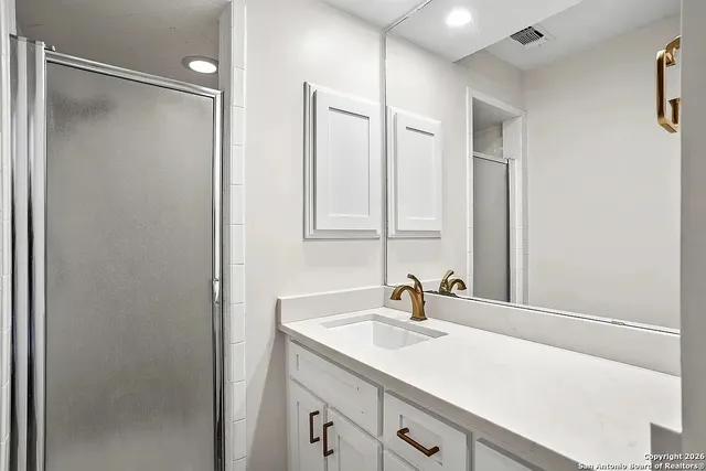 a bathroom with a sink double vanity and mirror