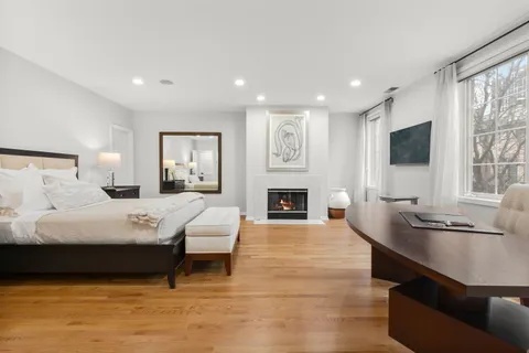 a bedroom with a large bed and a flat screen tv