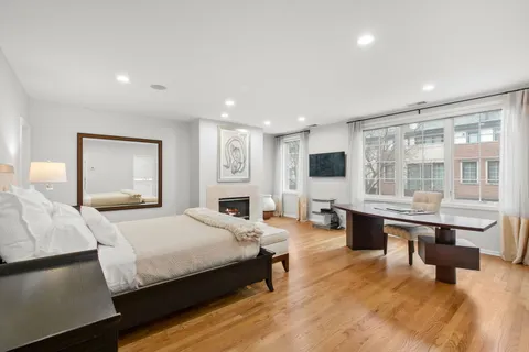 a bedroom with a large bed and a flat screen tv