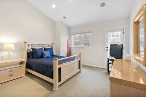 a bed room with a bed and a flat tv screen on a dresser