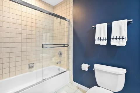 a bathroom with a toilet and a shower