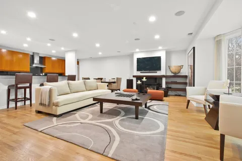 a living room with furniture kitchen view and a flat screen tv