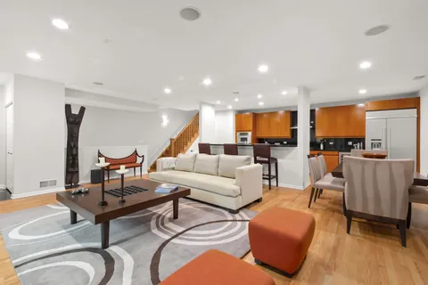 a living room with furniture and kitchen view