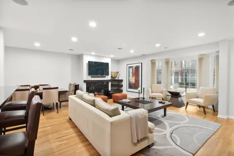a living room with fireplace furniture and a large window