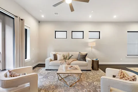 a living room with furniture and a lamp