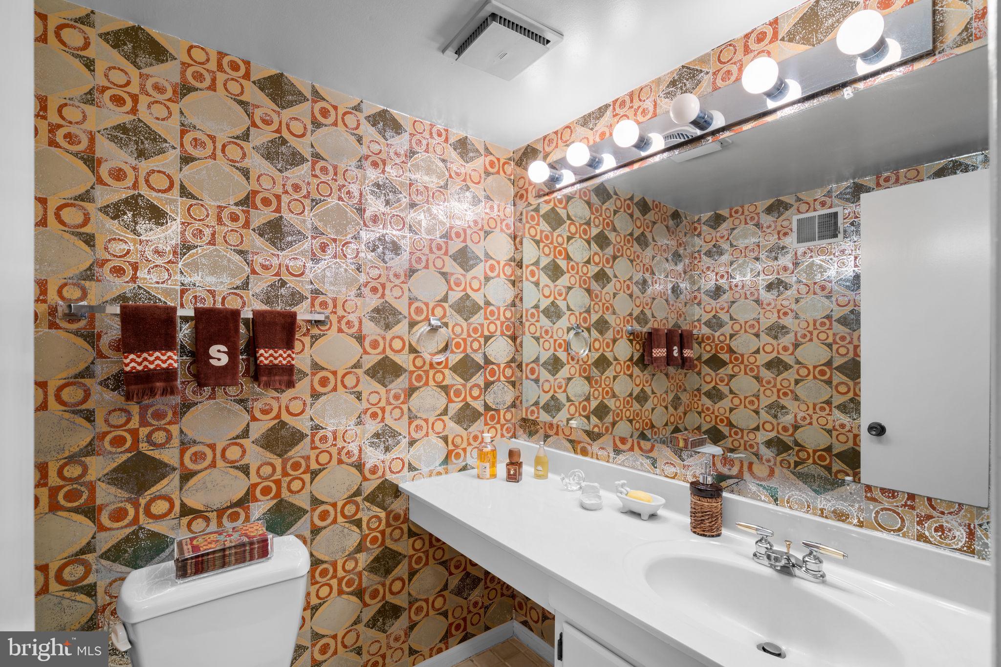 1709 Glastonberry Road Rockville, MD 20854 - Photo 17 of 27 a bathroom with a sink and a mirror