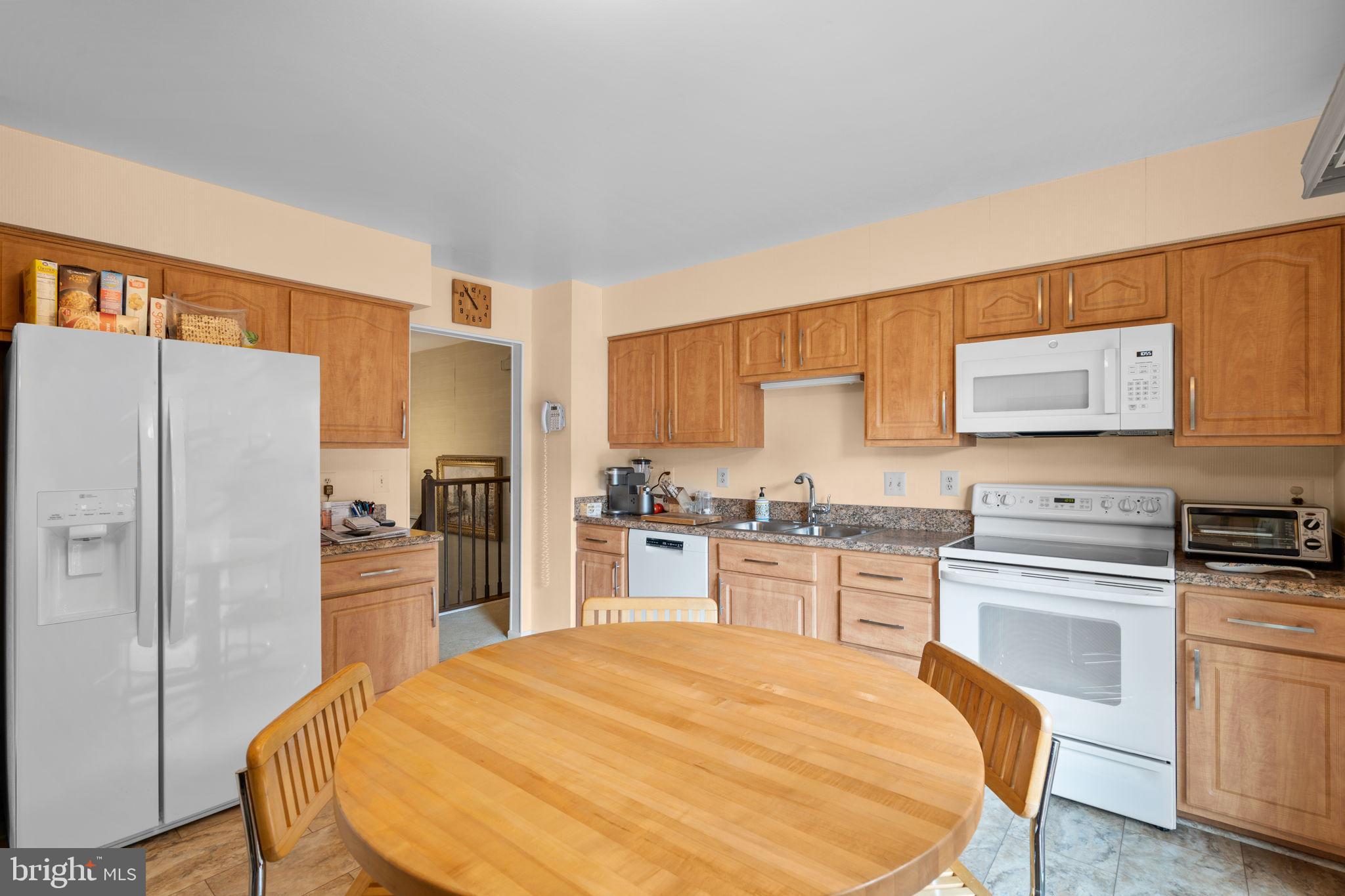 1709 Glastonberry Road Rockville, MD 20854 - Photo 5 of 27 a kitchen with stainless steel appliances a stove a refrigerator sink and cabinets