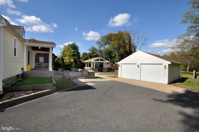 a view of a house with backyard and a garage