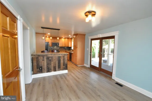a view of a kitchen with a sink and a refrigerator
