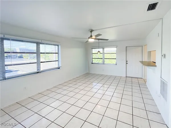 an empty room with windows and closet