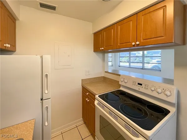 a kitchen with a stove top oven and cabinets