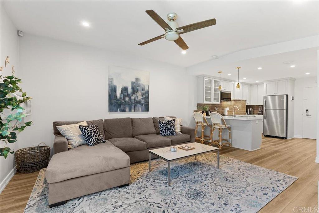 2003 Costa Del Mar Road, Unit 679 Carlsbad, CA 92009 - Photo 1 of 18 a living room with furniture and kitchen view