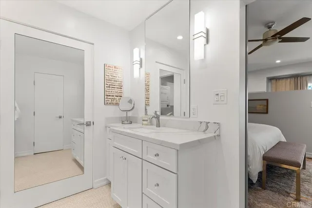 a spacious bathroom with a shower sink and mirror