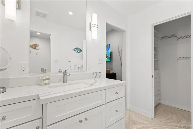 a bathroom with double vanity sink and a mirror