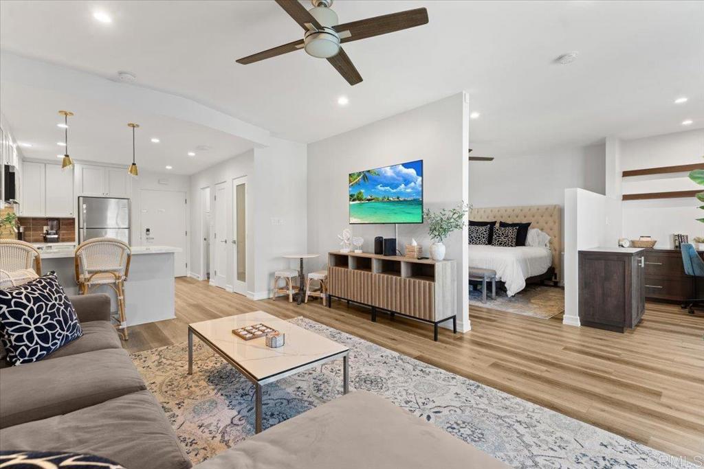 2003 Costa Del Mar Road, Unit 679 Carlsbad, CA 92009 - Photo 2 of 18 a living room with furniture and a flat screen tv