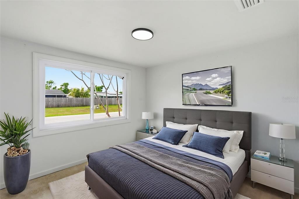 5421 64th Avenue North Pinellas Park, FL 33781 - Photo 15 of 43 a bedroom with a bed and a painting on the wall