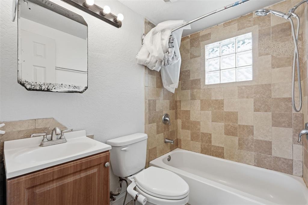 5421 64th Avenue North Pinellas Park, FL 33781 - Photo 20 of 43 a bathroom with a sink a toilet and shower