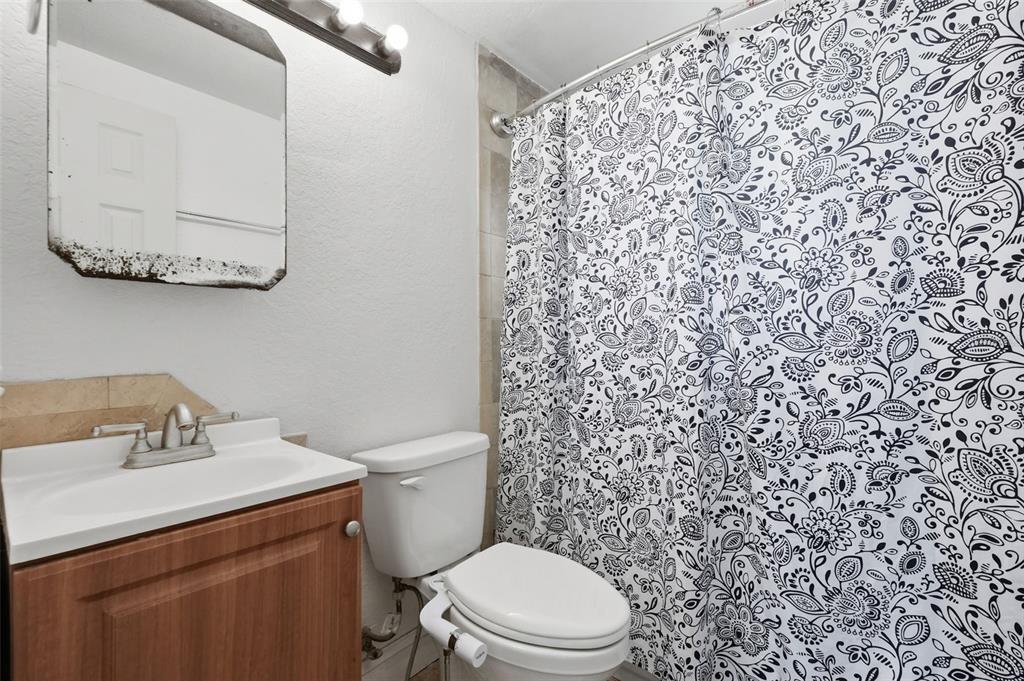 5421 64th Avenue North Pinellas Park, FL 33781 - Photo 21 of 43 a bathroom with a toilet sink and a mirror