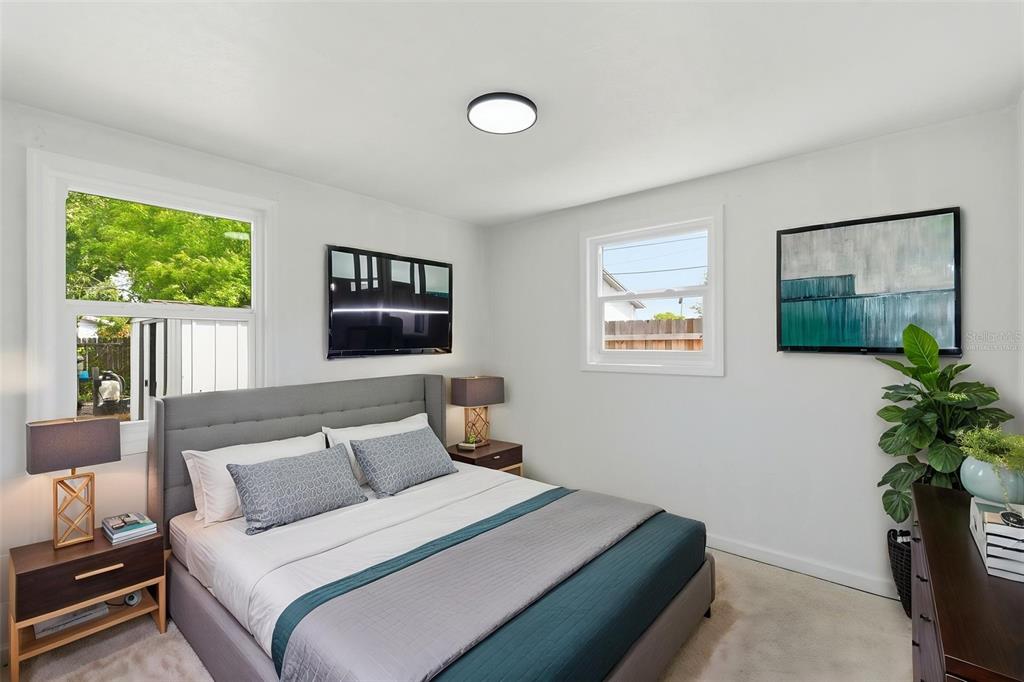 5421 64th Avenue North Pinellas Park, FL 33781 - Photo 23 of 43 a bedroom with a bed and a potted plant