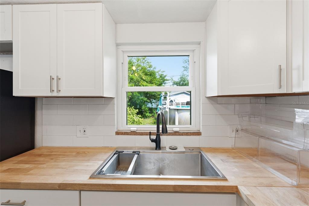 5421 64th Avenue North Pinellas Park, FL 33781 - Photo 3 of 43 a kitchen with granite countertop a sink and a window
