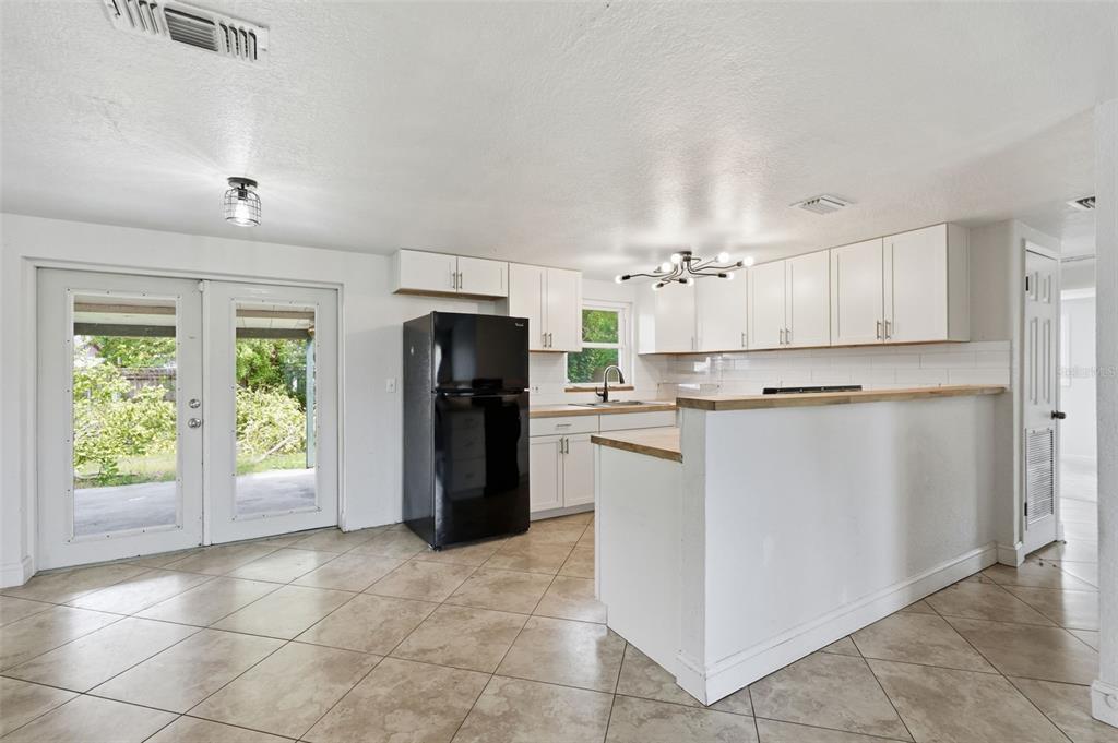 5421 64th Avenue North Pinellas Park, FL 33781 - Photo 4 of 43 a kitchen with stainless steel appliances granite countertop a refrigerator a stove a microwave and a refrigerator