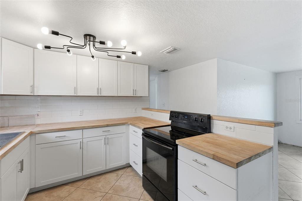 5421 64th Avenue North Pinellas Park, FL 33781 - Photo 7 of 43 a utility room with cabinets washer and dryer