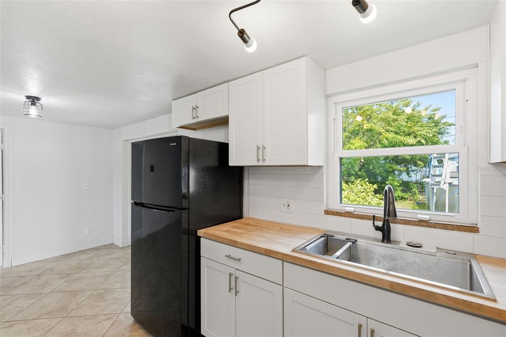 5421 64th Avenue North Pinellas Park, FL 33781 - Photo 8 of 43 a kitchen with a refrigerator and window