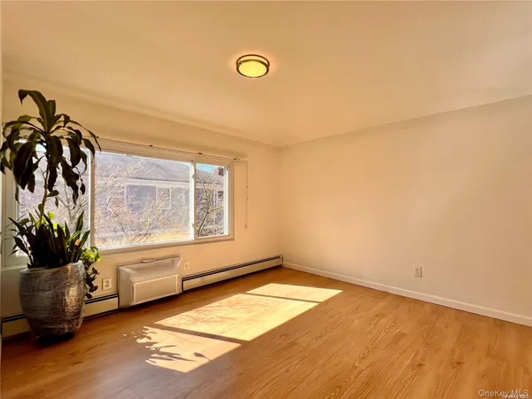 a view of a livingroom with wooden floor and a potted plant