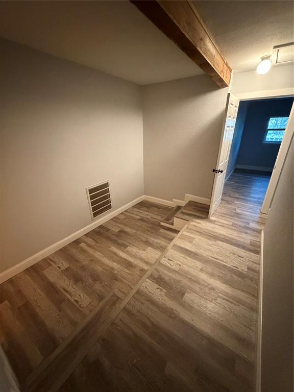 150 Ash Creek Court Springtown, TX 76082 - Photo 9 of 20 Upstairs office area featuring a wood beam and light colored floors