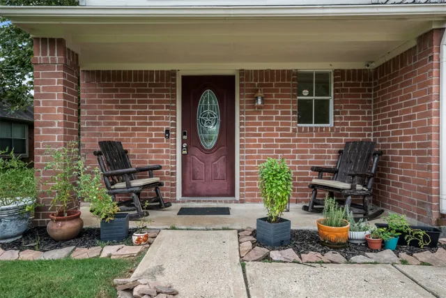 a backyard of a house with fire pit and outdoor seating