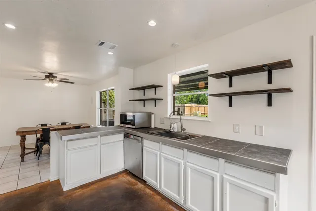 a kitchen with a sink cabinets and window