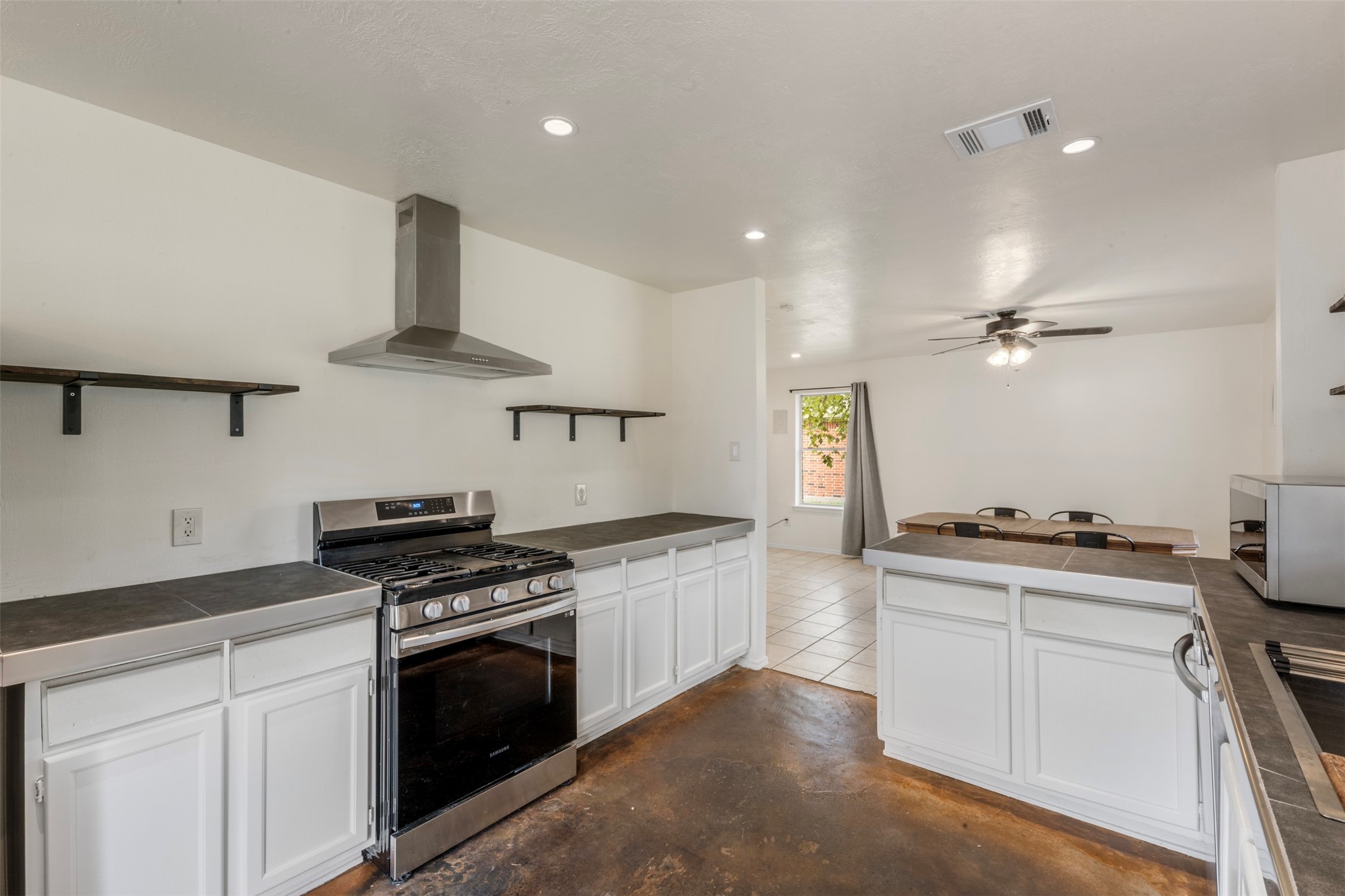 3722 Oaklace Drive Spring, TX 77389 - Photo 12 of 37 a kitchen with stainless steel appliances a stove a sink and a refrigerator