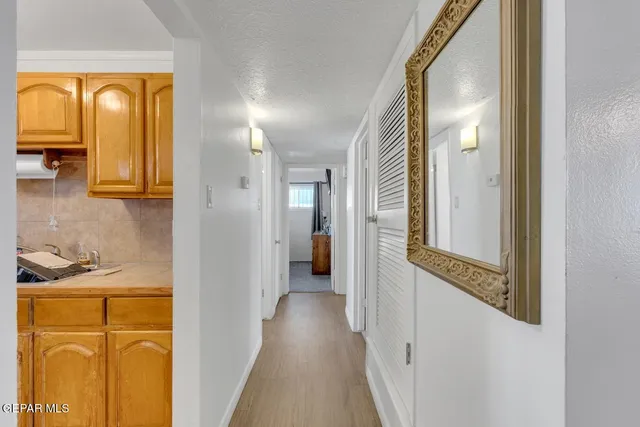 a view of a hallway with wooden floor