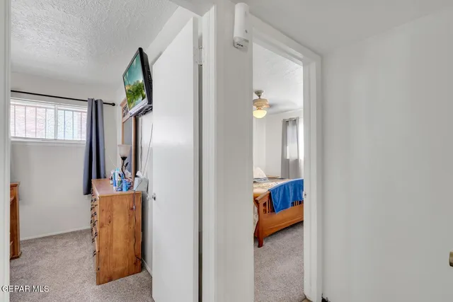 a view of a hallway with wooden floor and closet