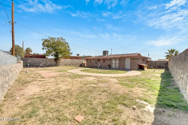 a view of a swimming pool with a yard