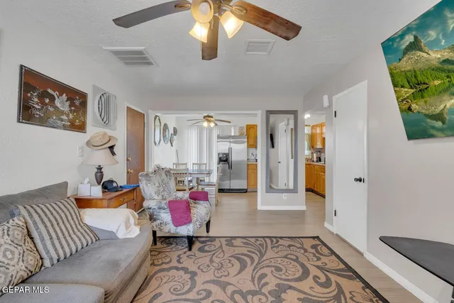 a living room with furniture and a chandelier