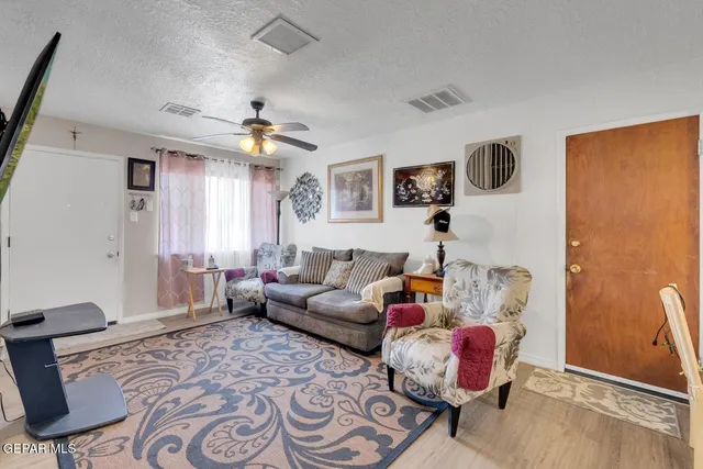 a living room with furniture and wooden floor