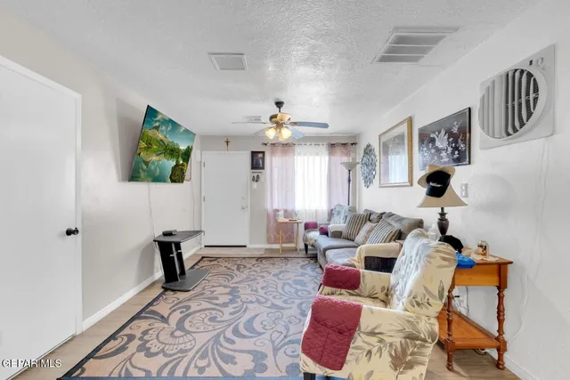 a living room with furniture and wooden floor