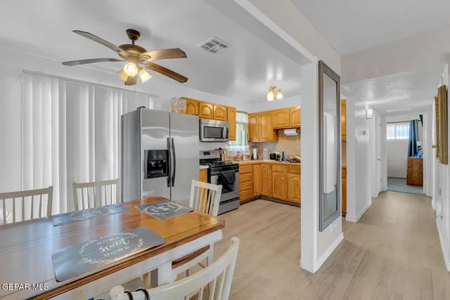 a kitchen with stainless steel appliances granite countertop a refrigerator and a sink