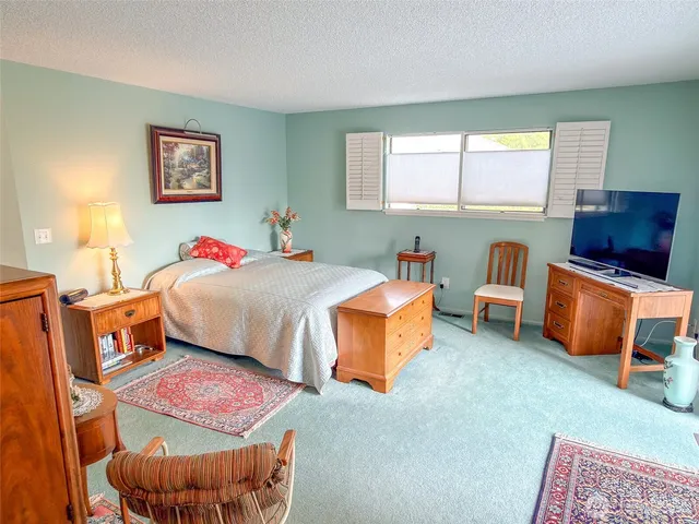 a bedroom with furniture and a window