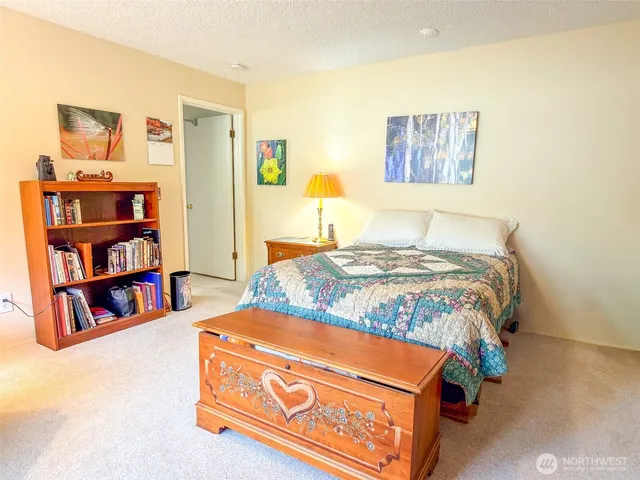 a bedroom with a bed and a book shelf