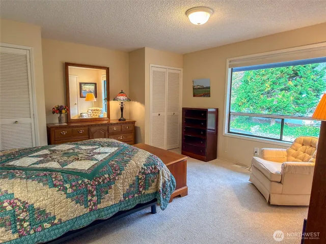 a bedroom with a bed and a couch