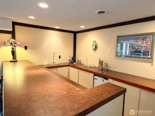 a kitchen with stainless steel appliances granite countertop a sink a stove and a refrigerator