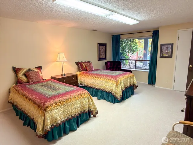 a bedroom with two beds and a window